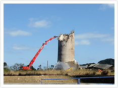 Demolition work performed using a large backhoe